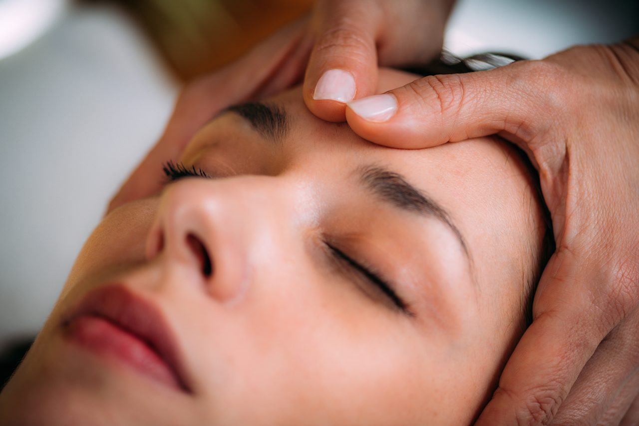 cst therapist massaging woman's head craniosacral